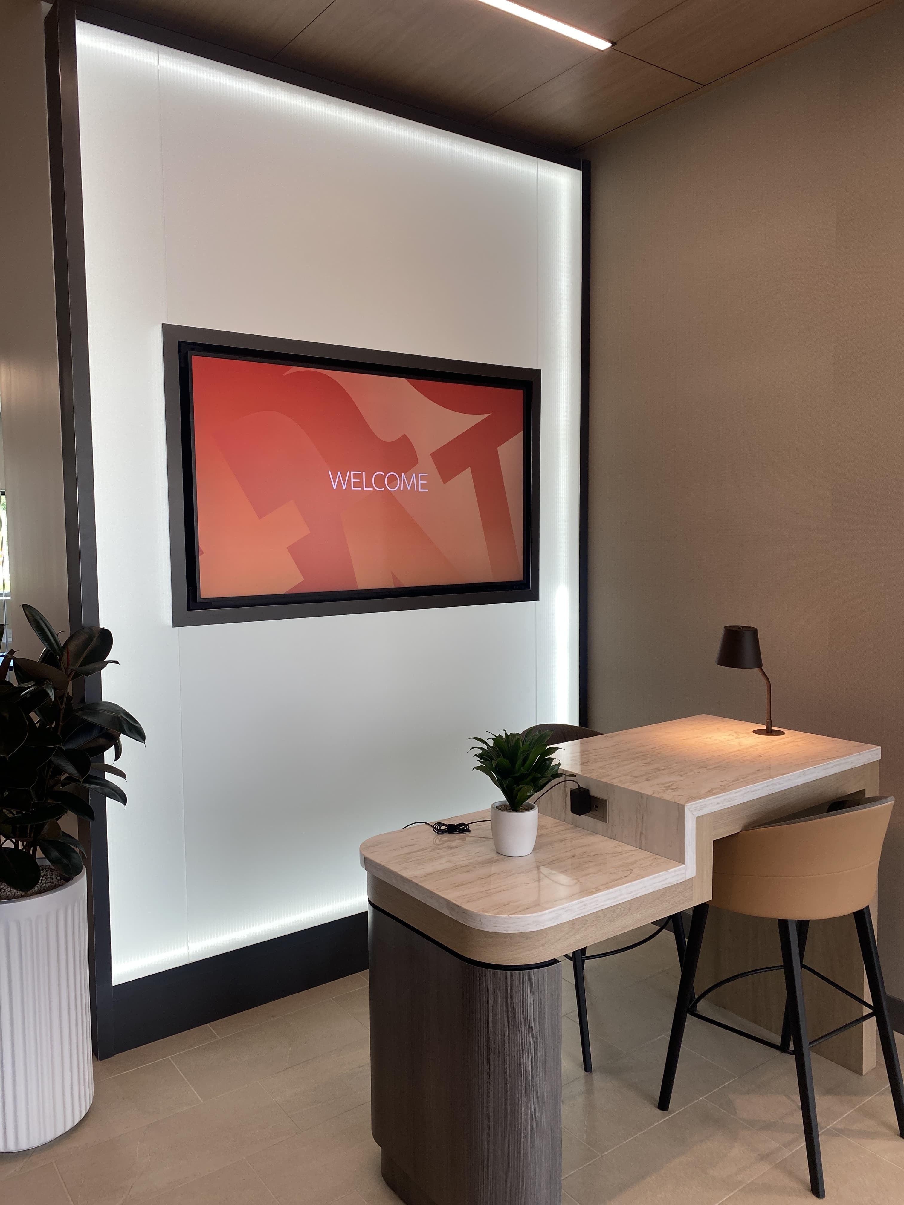 Finished commercial office interior with installed custom millwork and red artwork by Deerfield Interiors, New York City
